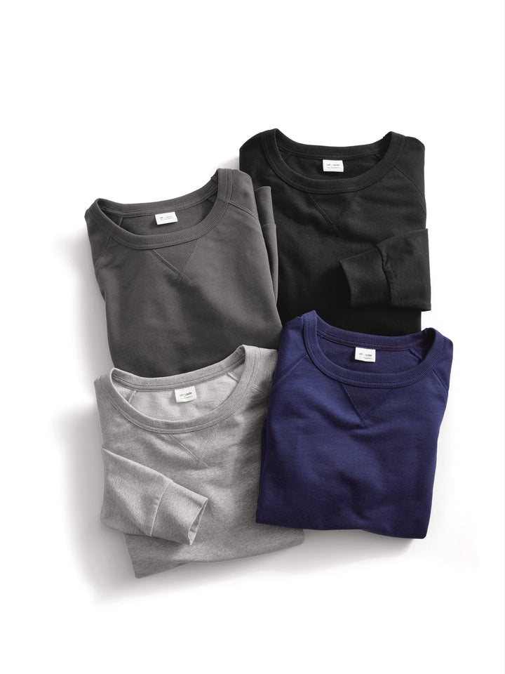 Folded Custom Allmade Organic French Terry Crewnecks in black, dark gray, navy, and heather gray. A premium selection of sustainable sweatshirts.