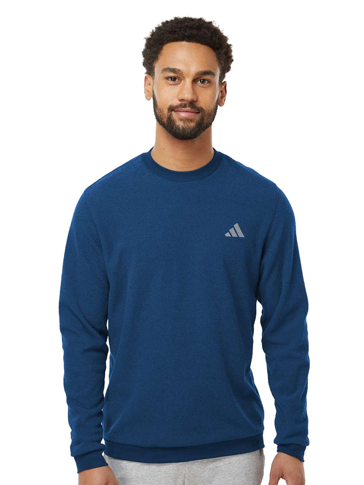 Blue Adidas crewneck sweatshirt featuring a sleek embroidered logo on the chest. Designed for comfort and everyday wear.