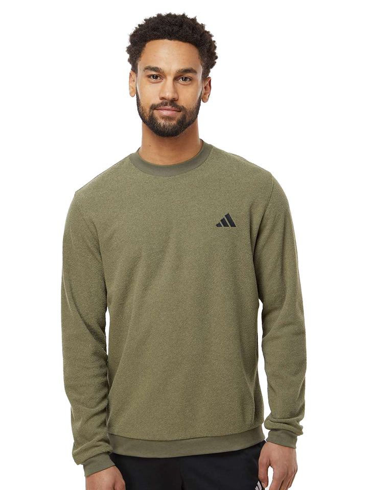 Olive green Adidas crewneck sweatshirt with a subtle embroidered logo. A stylish and comfortable choice for casual and athletic wear.
