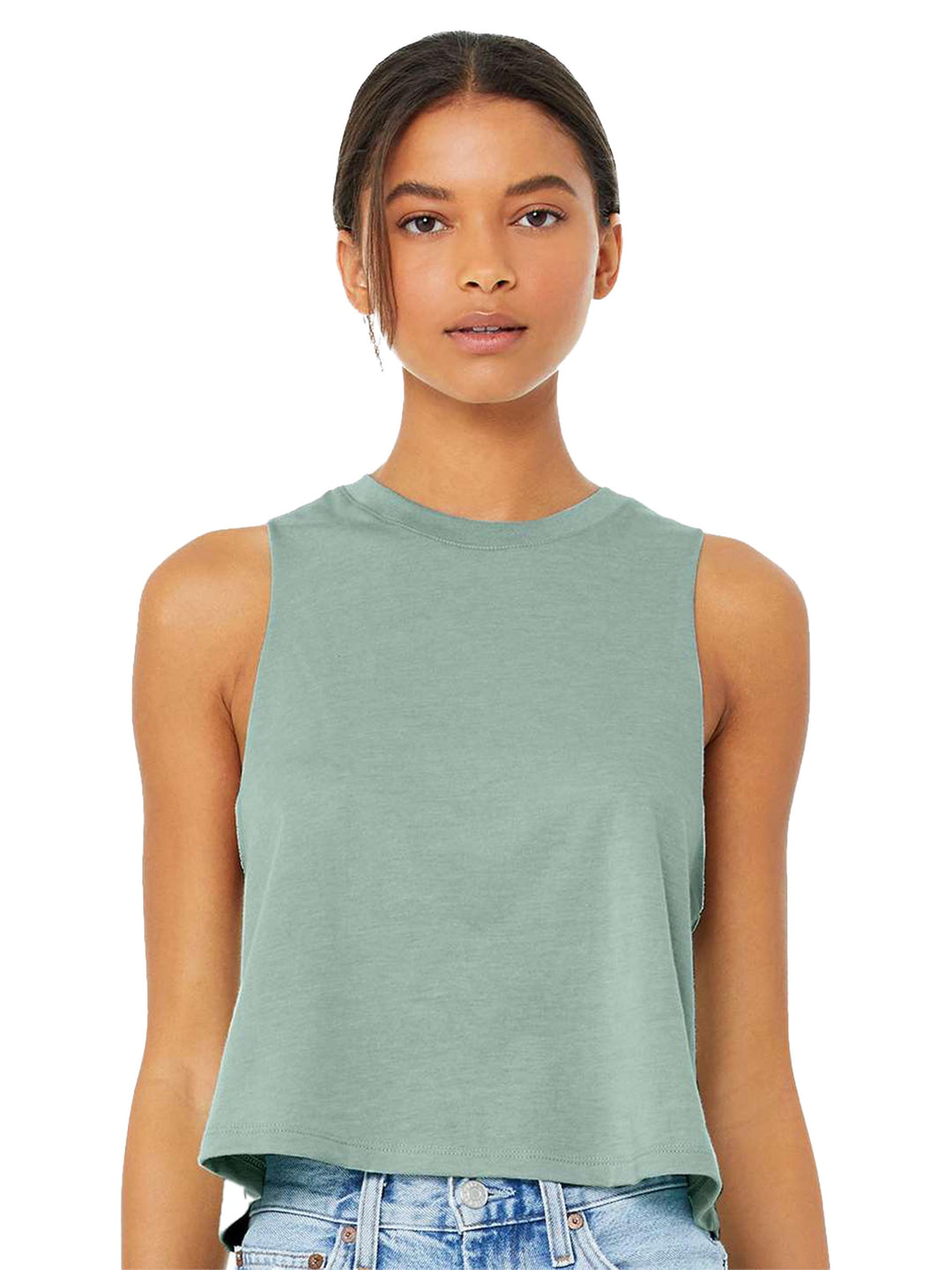 Bella + Canvas Women’s Racerback Crop Tank in sage green, featuring a sleeveless, cropped design. Styled with denim for a casual look.