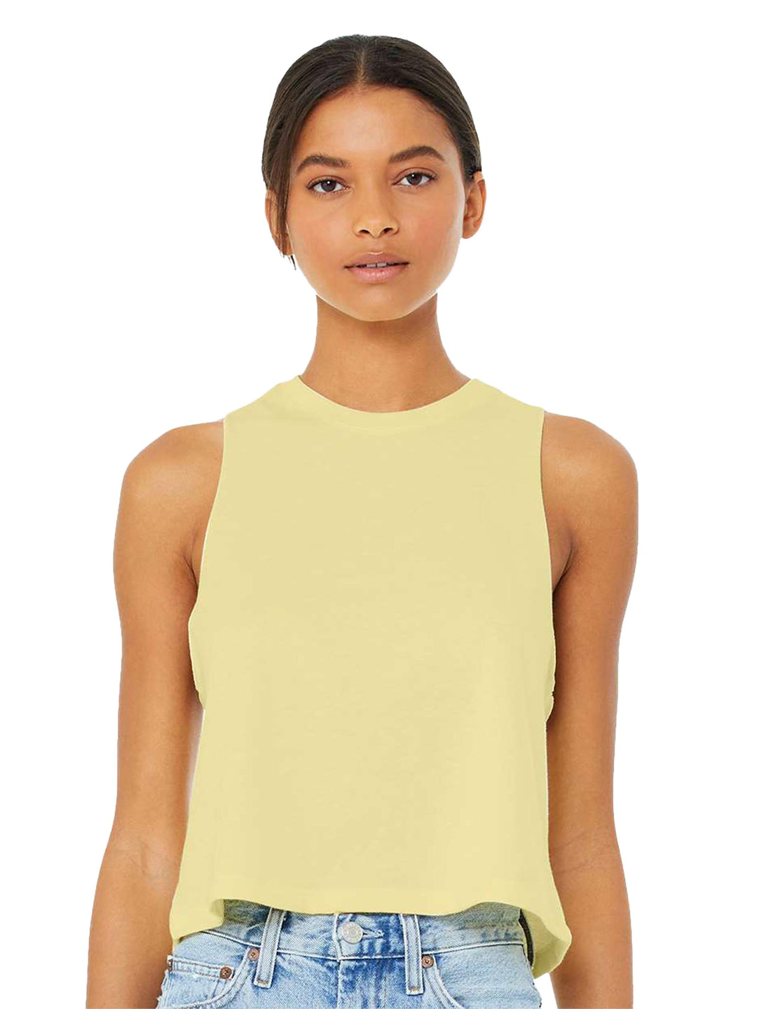 Bella + Canvas Women’s Racerback Crop Tank in pastel yellow, offering a lightweight, sleeveless design. Styled with denim for a trendy look.