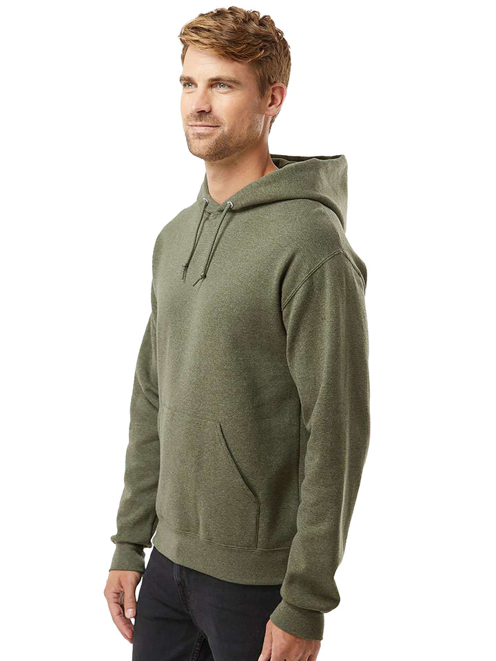 Side view of the Jerzees NuBlend Hoodie in olive green, showcasing its relaxed fit, ribbed cuffs, and durable fabric for everyday wear.