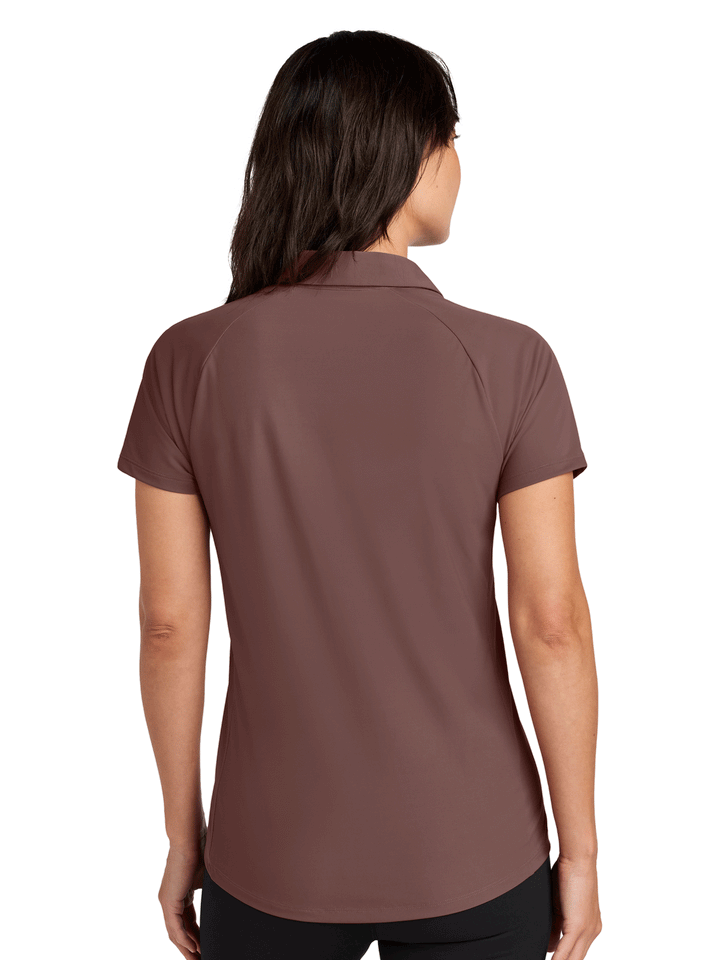 Back view of OGIO Women’s Envision Polo in brown, highlighting tailored seams and moisture-wicking performance for custom branding.