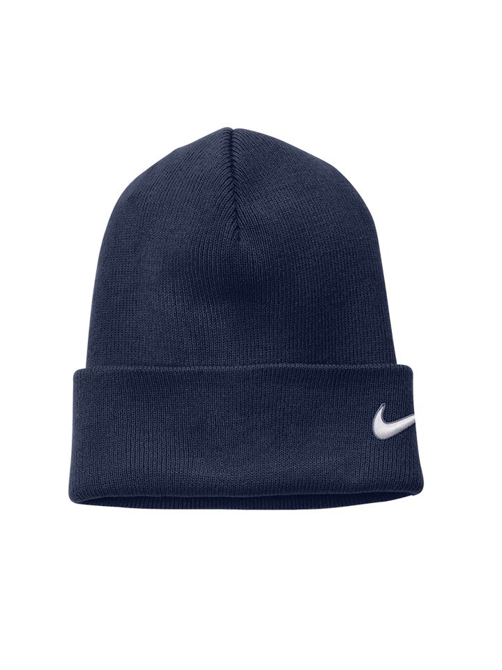 Navy blue Nike Team Cuffed Beanie featuring an embroidered white swoosh logo on the side. A stylish and cozy winter hat.