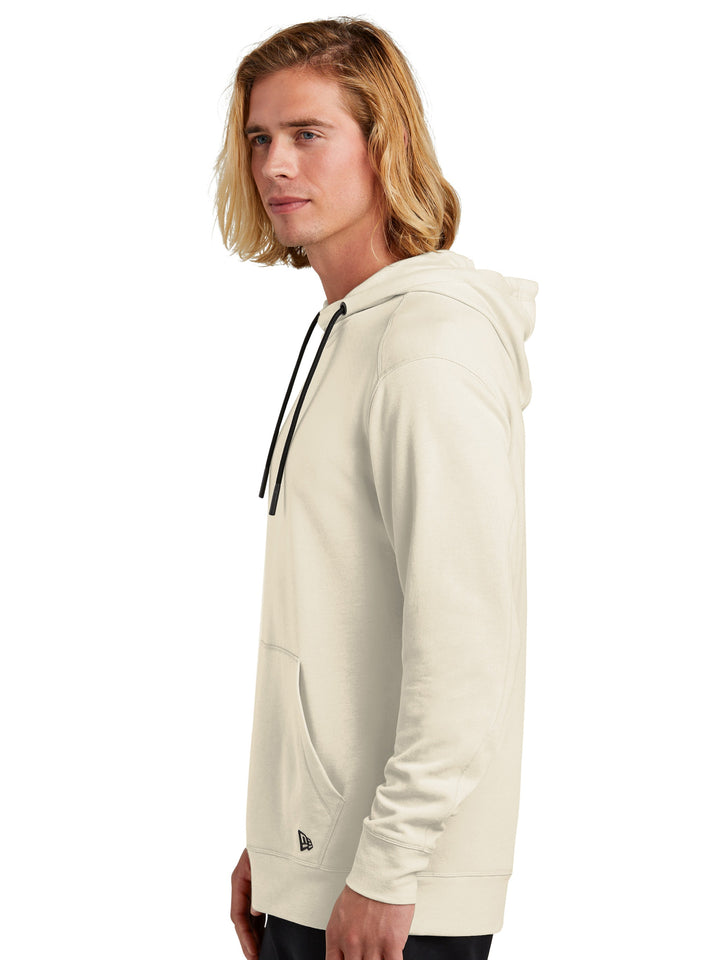 Side view of the New Era Tri-Blend Fleece Hoodie in off-white, showcasing its modern fit, soft fabric blend, and stylish drawstring hood.