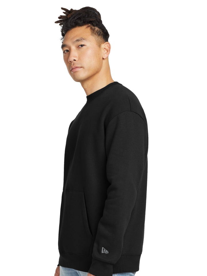 Side view of the New Era Heritage Fleece Pocket Crewneck in black, showcasing its relaxed fit and soft fleece fabric. Ideal for customization.