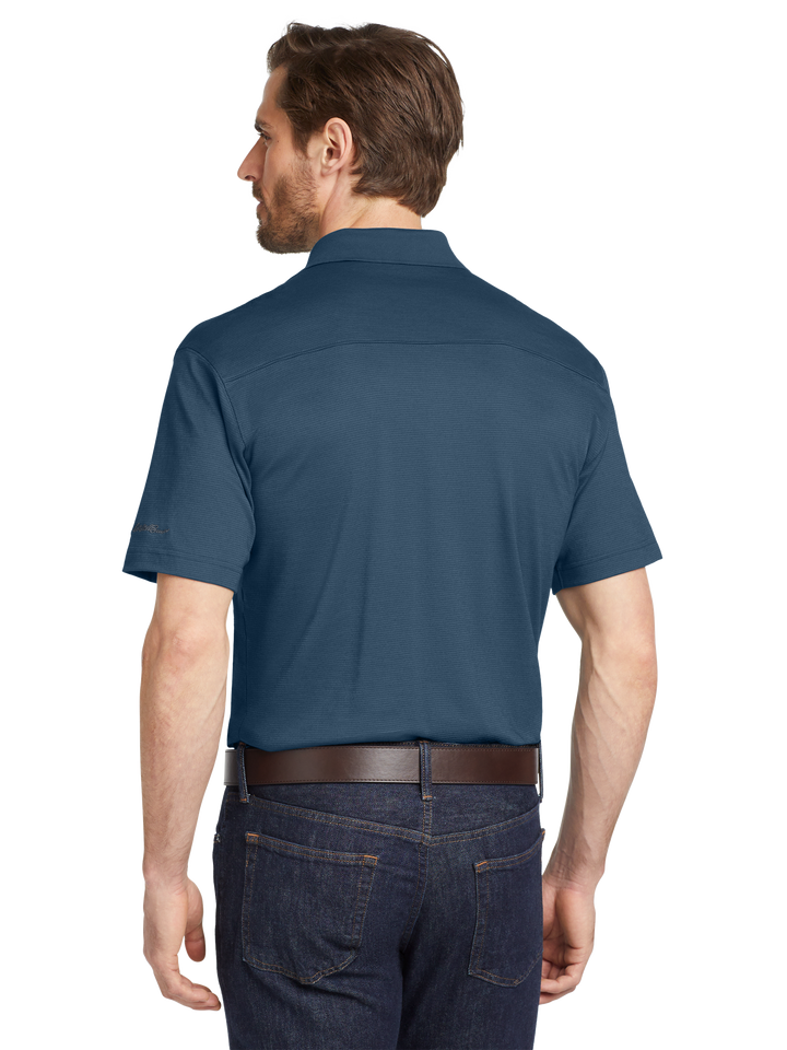 Back view of Eddie Bauer® Performance Polo in deep blue, highlighting durable stitching and a comfortable fit. Perfect for work or leisure.