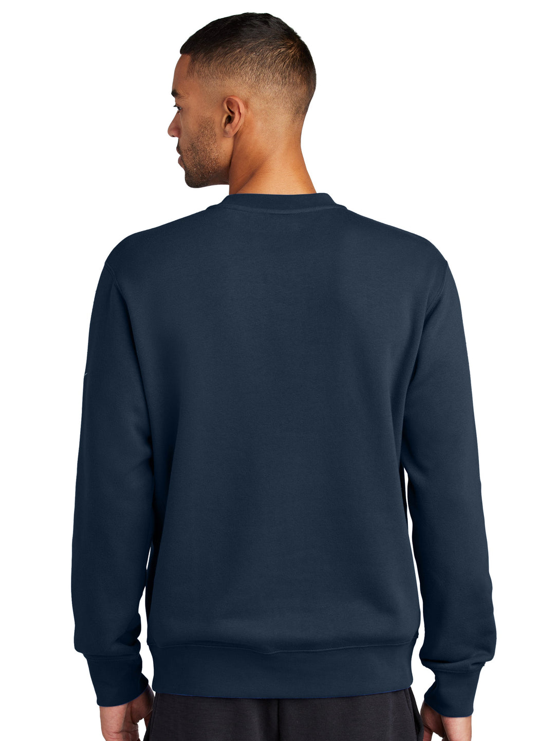 Back view of the Nike Club Fleece Crewneck in navy, highlighting its relaxed fit and ribbed cuffs. A great option for custom embroidery or printing.