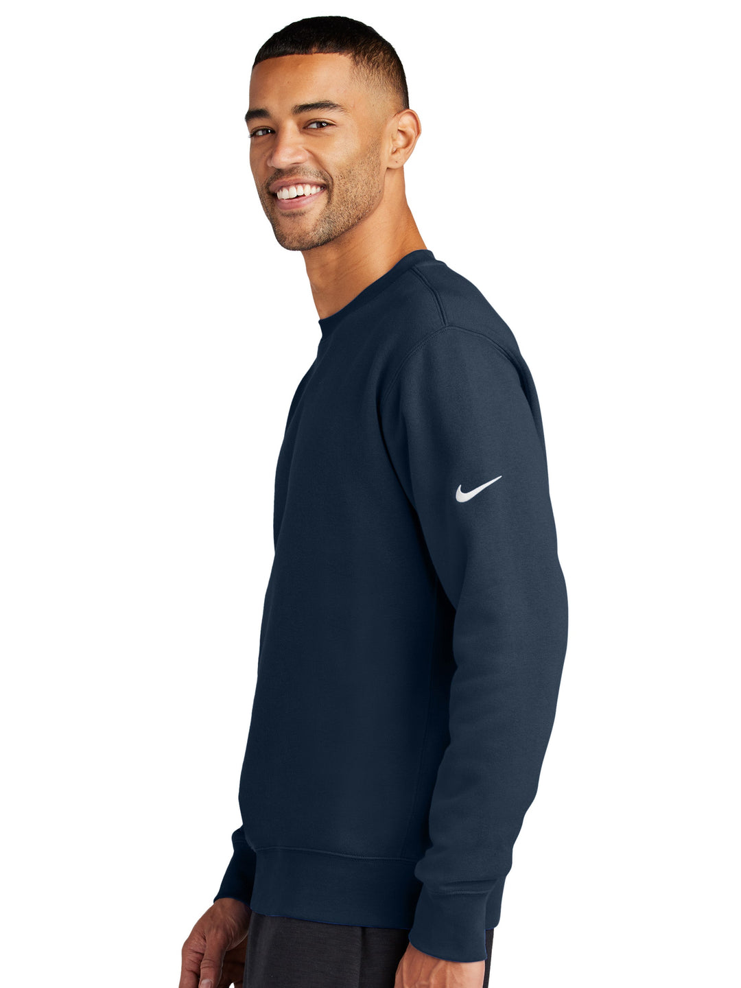 Side view of the Nike Club Fleece Crewneck in navy, showcasing the embroidered Nike swoosh on the sleeve. Ideal for personalized branding or everyday wear.