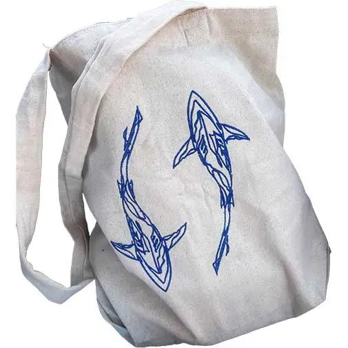Shark embroidered canvas tote bag featuring two blue shark designs on durable beige fabric. Perfect for ocean lovers and everyday use.