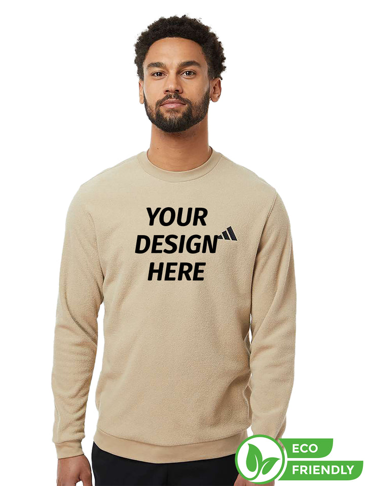 Customizable Adidas crewneck sweatshirt in beige with 'Your Design Here' text, ideal for personalized branding. Eco-friendly and made for comfort.