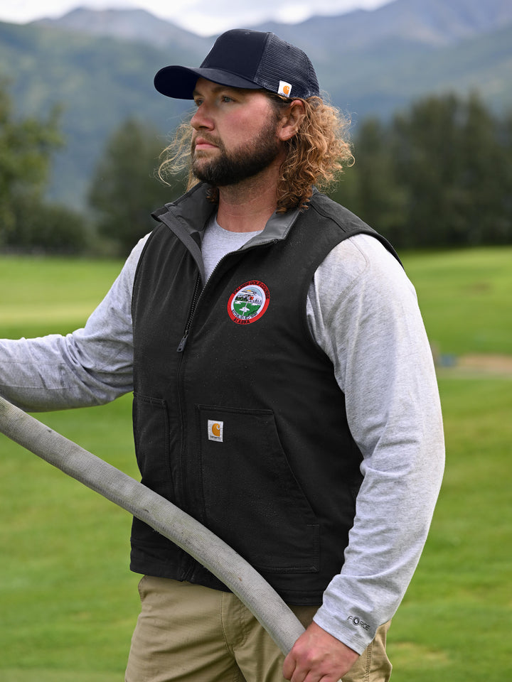 Man wearing navy Custom Carhartt Canvas Mesh Back Cap while working outdoors, highlighting its rugged design and breathable mesh back.