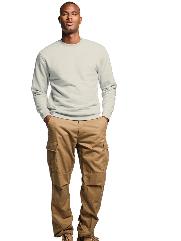 Model wearing a plain light sage crewneck sweatshirt. Classic fit with soft fabric for everyday wear.