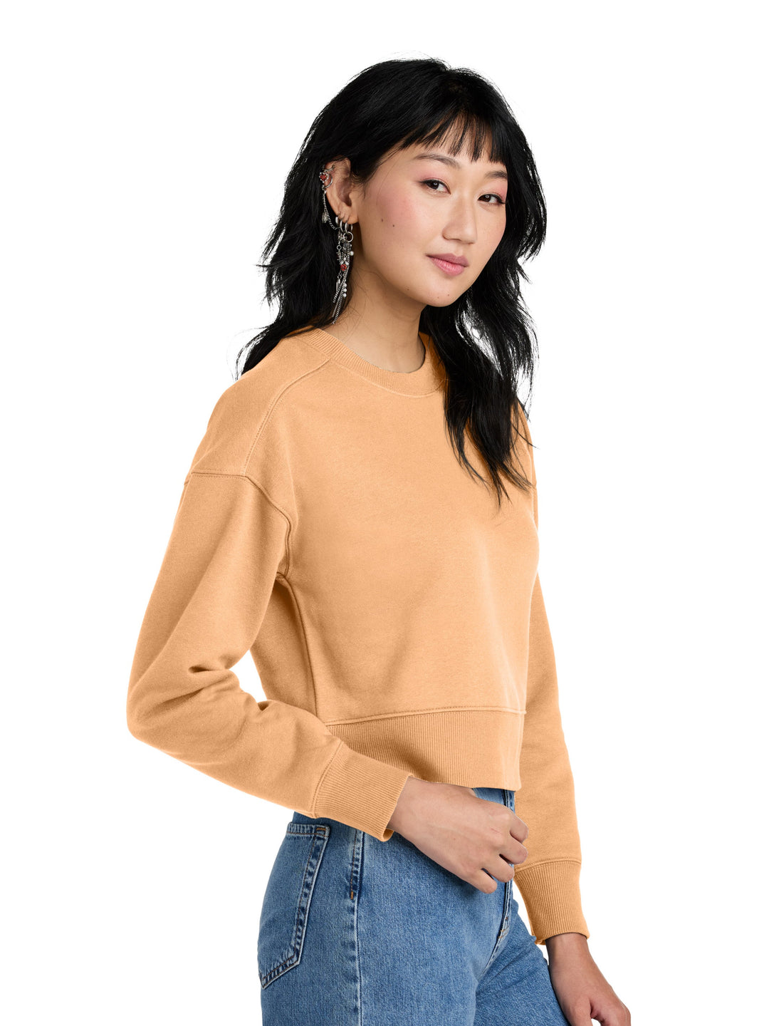 Side view of District Women's Perfect Weight Fleece Cropped Crewneck in camel color, showcasing its soft fleece fabric and cropped length.