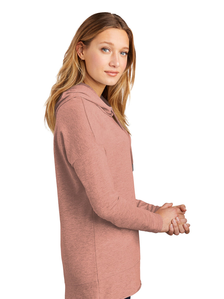 Side view of the Custom District Women's Featherweight French Terry Hoodie in pink, showcasing its soft fabric, long sleeves, and stylish drape for a comfortable fit.