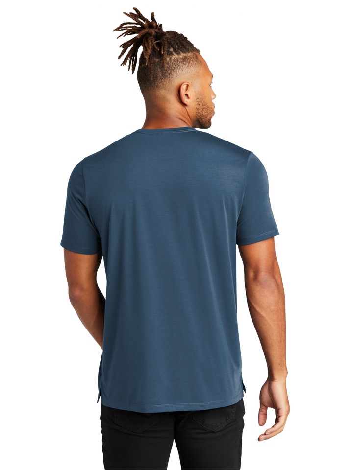 Back view of Mercer+Mettle Stretch Jersey Crew MM1016 in blue, showcasing its smooth fabric, relaxed fit, and subtle side slits for added comfort.
