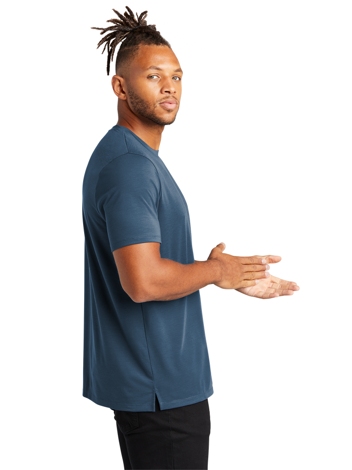 Side view of Mercer+Mettle Stretch Jersey Crew MM1016 in blue, highlighting its breathable stretch fabric and stylish side slit hem design.