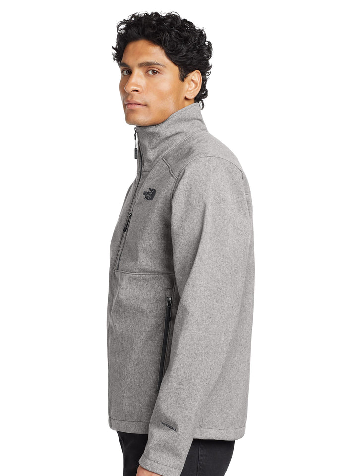 Side profile of The North Face® Apex Barrier Soft Shell Jacket in heather gray, highlighting zippered pockets and sleek fit.