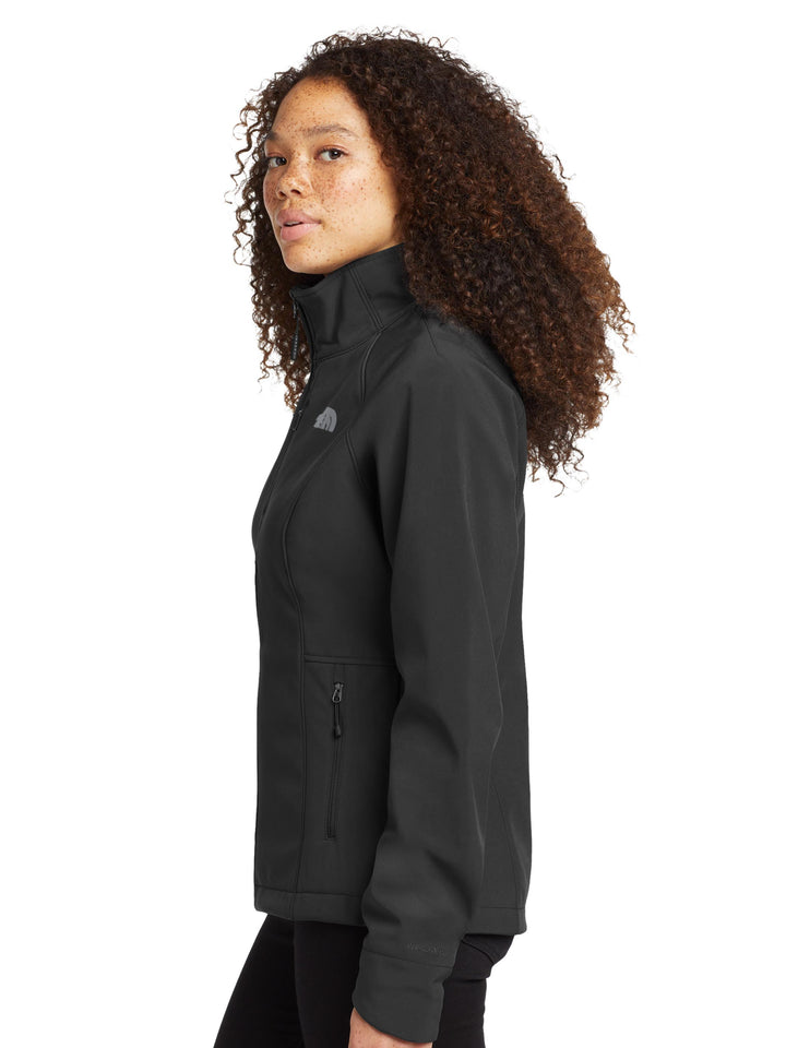 Side profile of The North Face® Women's Apex Barrier Soft Shell Jacket in black, featuring zippered pockets and sleek silhouette for active use.