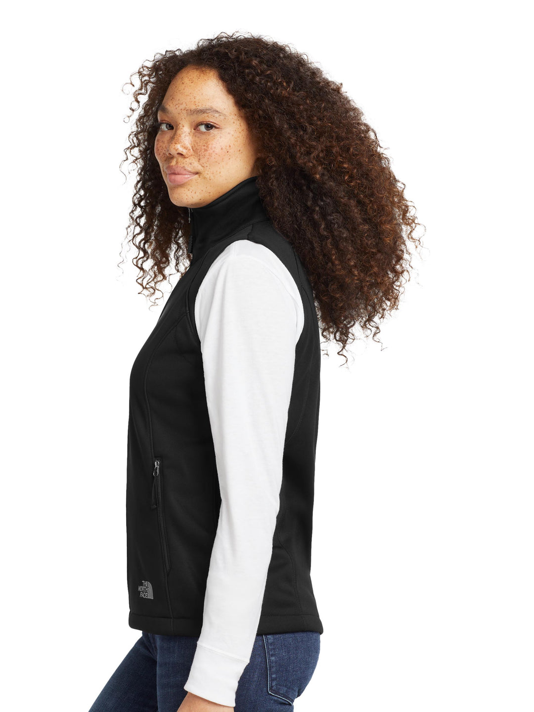 Side view of The North Face® Women's Ridgewall Soft Shell Vest in black, showcasing sleek fit and zippered pockets for customizable outerwear.