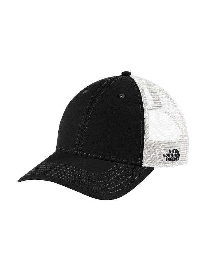 Black and white The North Face Ultimate Trucker Cap with structured front and breathable mesh, ideal for branded apparel collections.