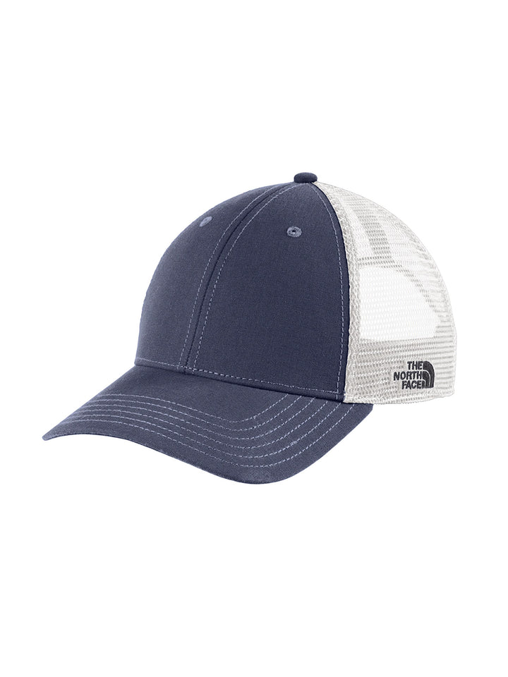The North Face Ultimate Trucker Cap in navy with white mesh and logo on side, perfect for casual outdoor wear and brand promotion.
