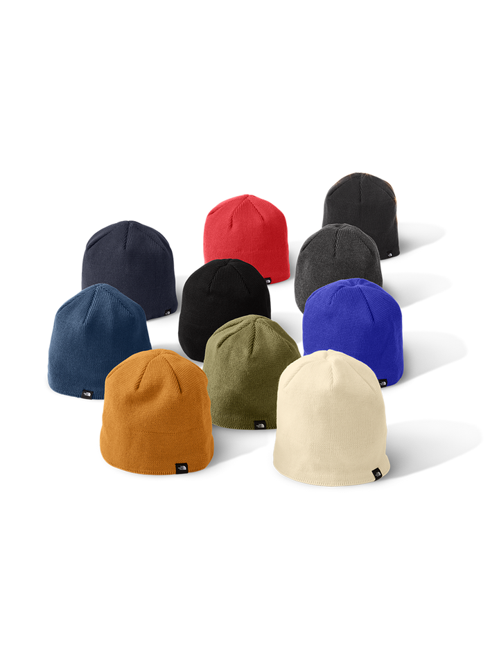 Collection of The North Face® Mountain Beanies in various colors, including black, blue, red, and beige. Perfect for customization and outdoor wear.