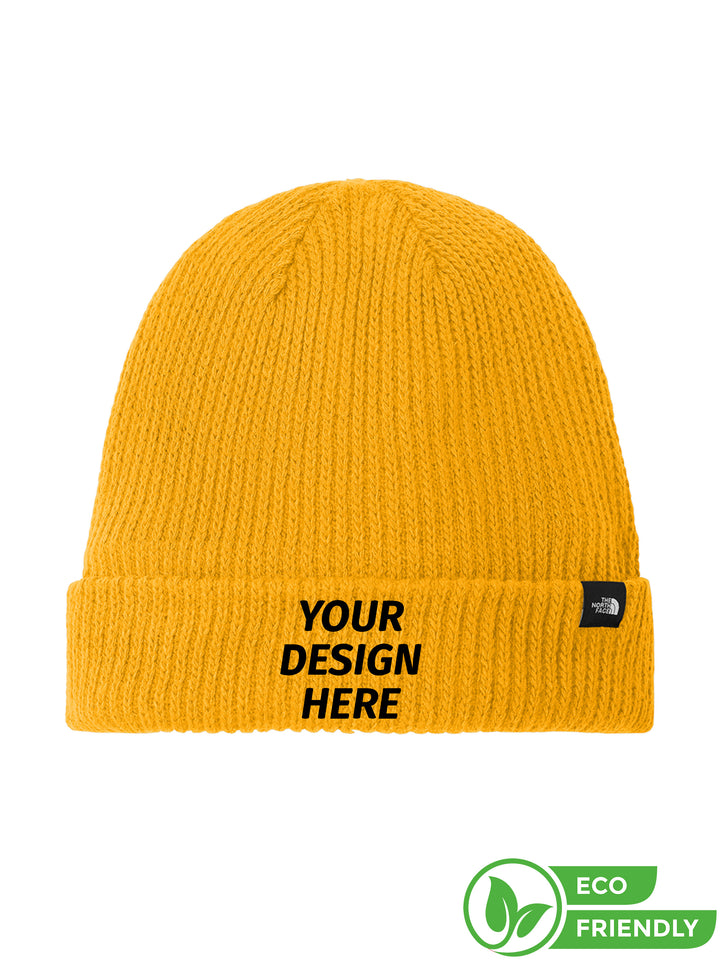 Custom The North Face® Circular Rib Beanie in yellow with 'Your Design Here' text. Eco-friendly knit hat with fold-over cuff, ideal for embroidery.