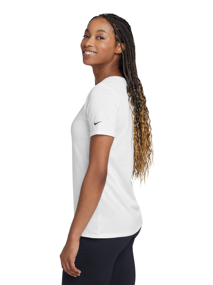 Side view of the Nike Women's Dri-FIT Cotton/Poly Scoop Neck Tee- NKBQ5234 in white, highlighting the Nike swoosh logo on the sleeve.