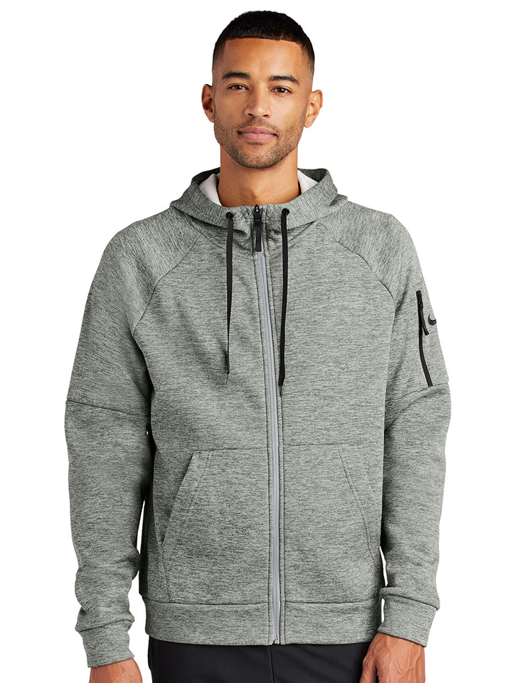 Heathered light gray Nike Therma-FIT zip-up hoodie with full-zip closure. Customizable for corporate branding, sports teams, or personal use.