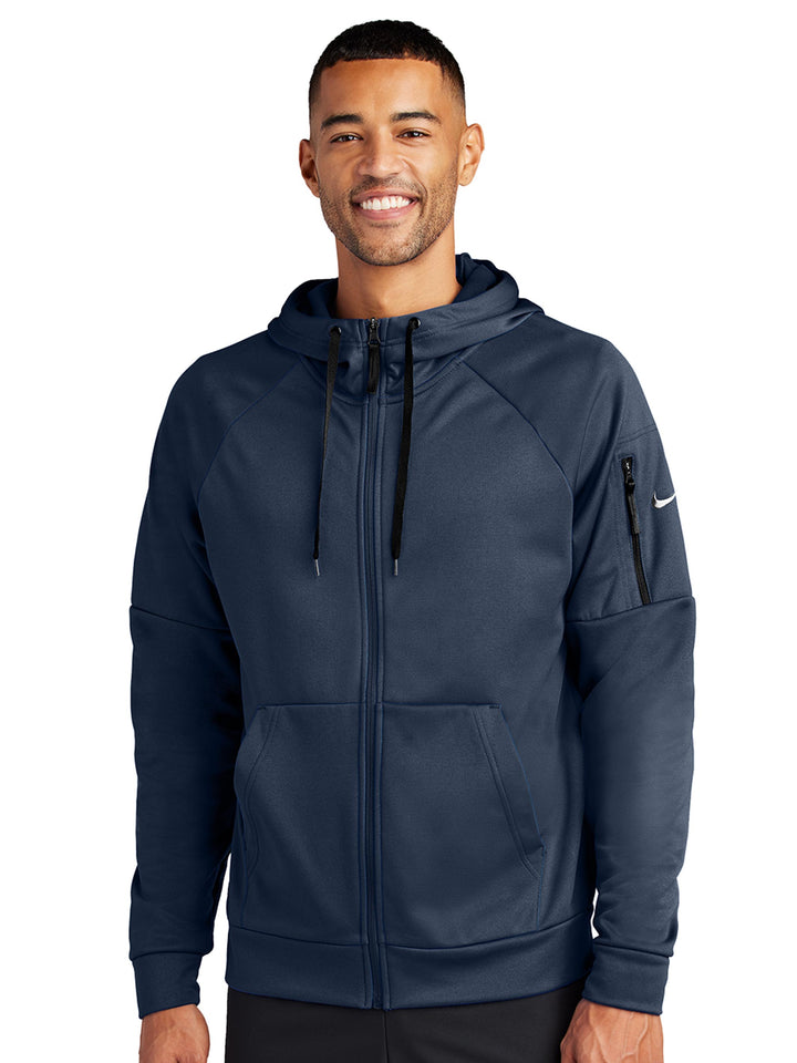 Navy blue Nike Therma-FIT zip-up hoodie with full-zip closure and sleeve pocket. Ideal for custom embroidery or printing with no minimum order.