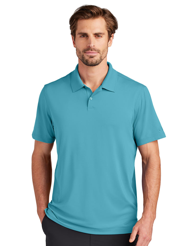 Custom OGIO Regain Polo in teal, featuring a stylish and comfortable design with moisture-wicking properties. Great for work or casual occasions.