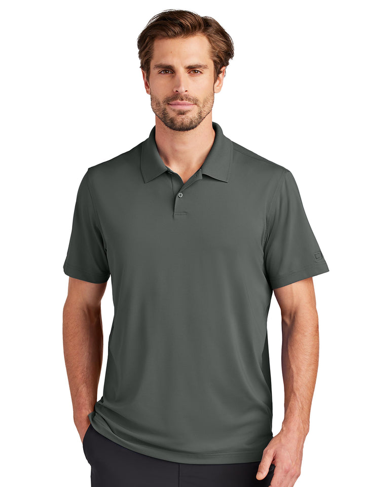 Custom OGIO Regain Polo in dark green, offering a sleek and modern fit with moisture-wicking fabric. Great for work or casual occasions.