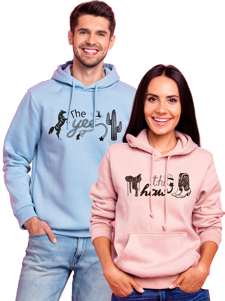 Custom matching 'The Yee' and 'The Haw' hoodies in pastel blue and pink, featuring western-themed graphics. Perfect for couples looking for stylish sweatshirts.