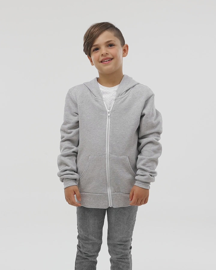 A child wearing the Bella + Canvas Youth Fleece Zip Up Hoodie in heather gray, demonstrating its relaxed fit and stylish casual look.